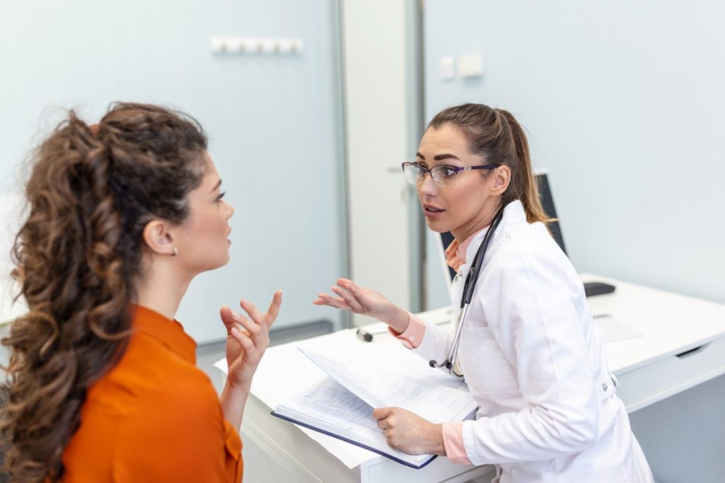 female medical professional talking to a patient