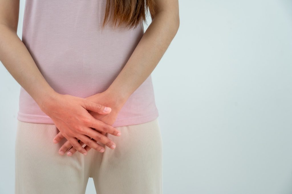 woman touching lower abdomen