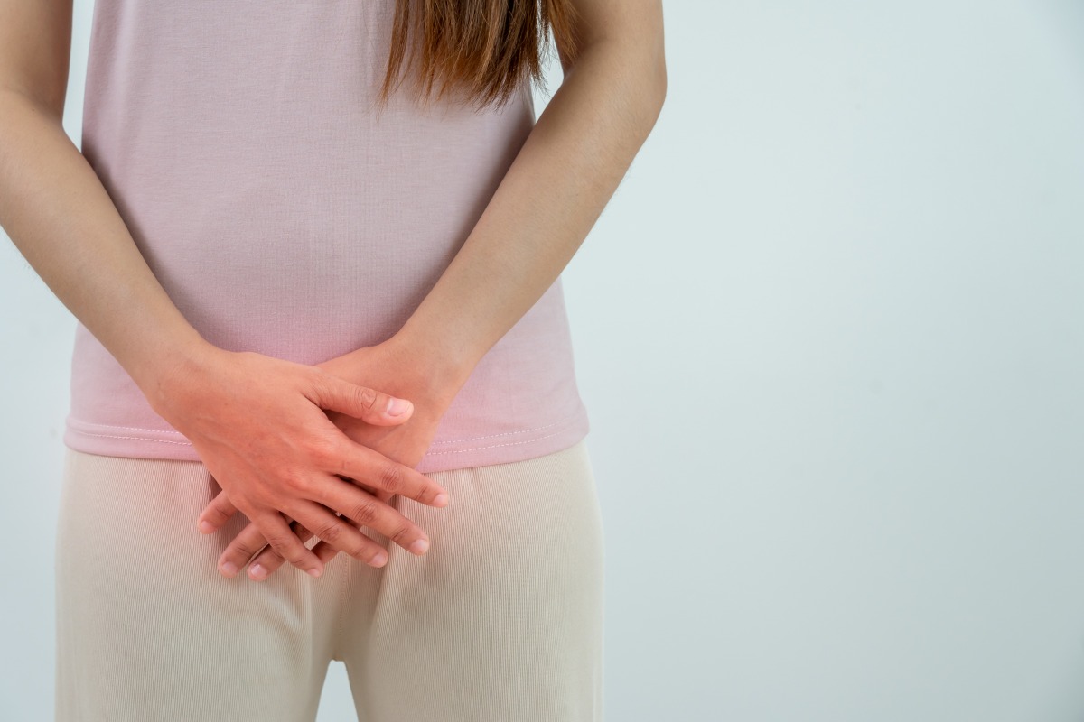 woman touching lower abdomen