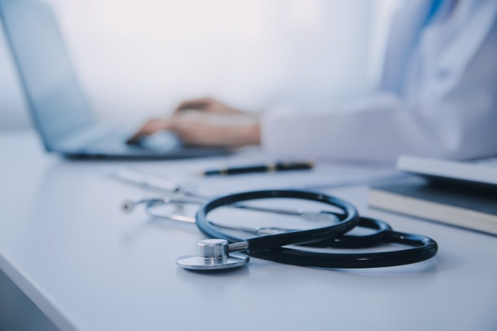 close up shot of stethoscope with a doctor at the background