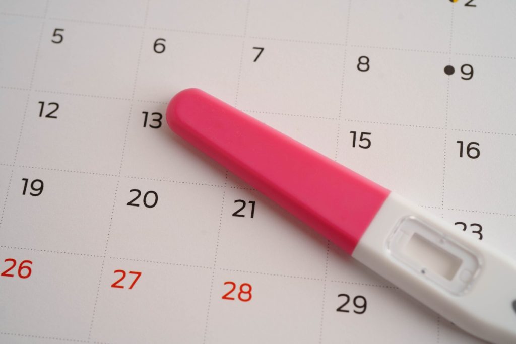 calendar and pink ovulation test kit