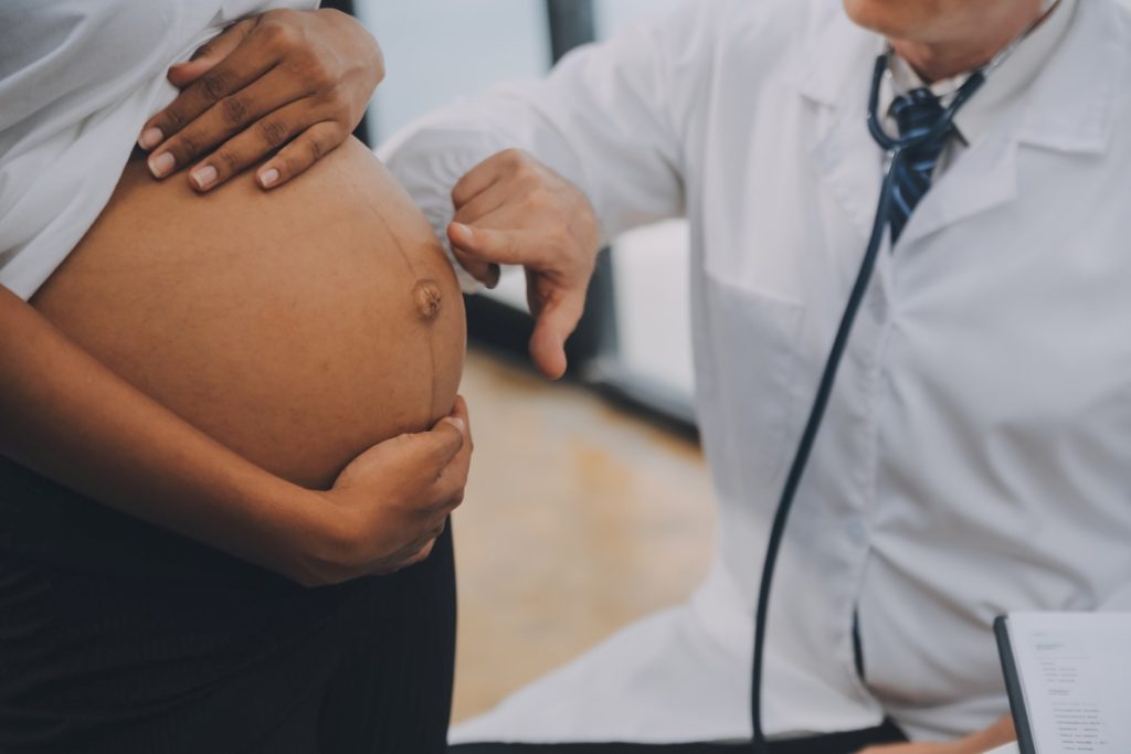 Female doctor is checking pregnant woman