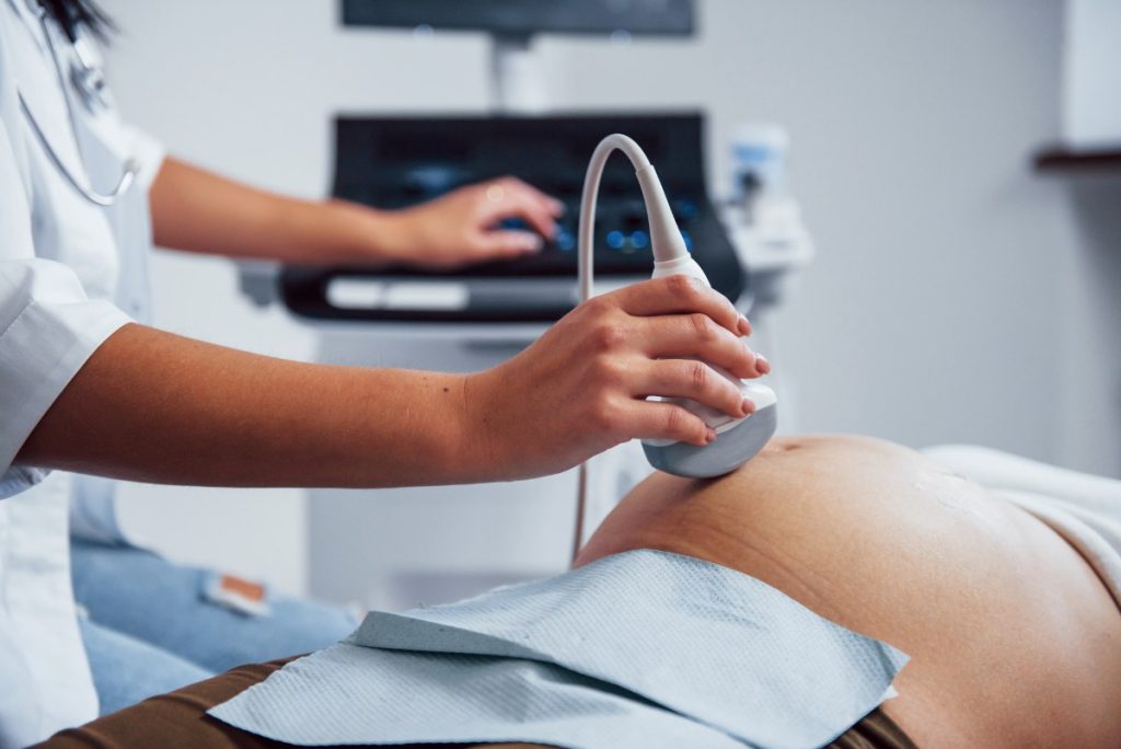 doctor does ultrasound for a pregnant woman