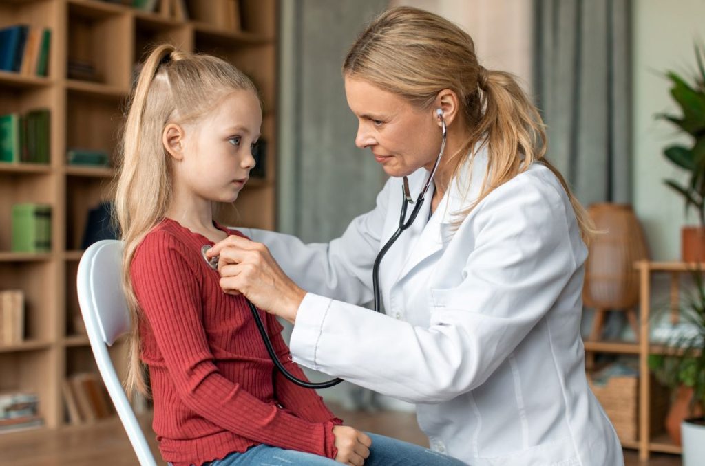 Female doctor checking child during medical checkup