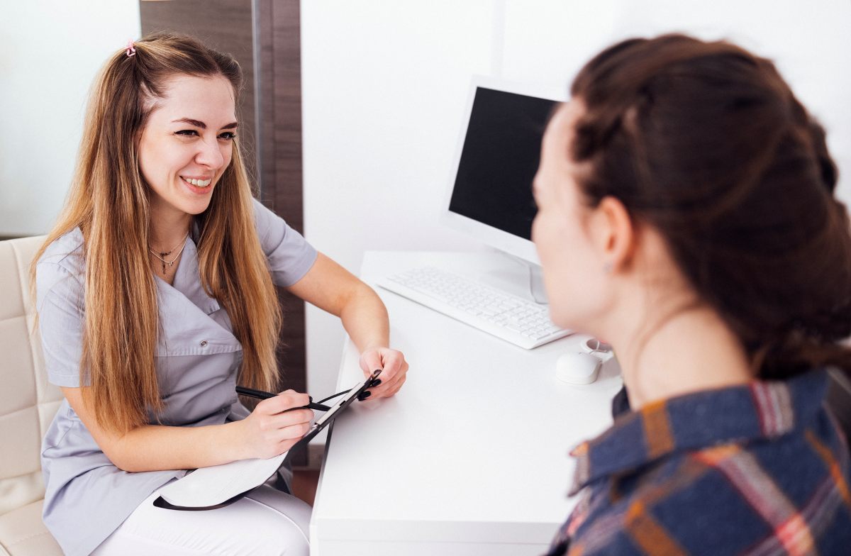 Professional Gynaecologist examines teenage girl in her office