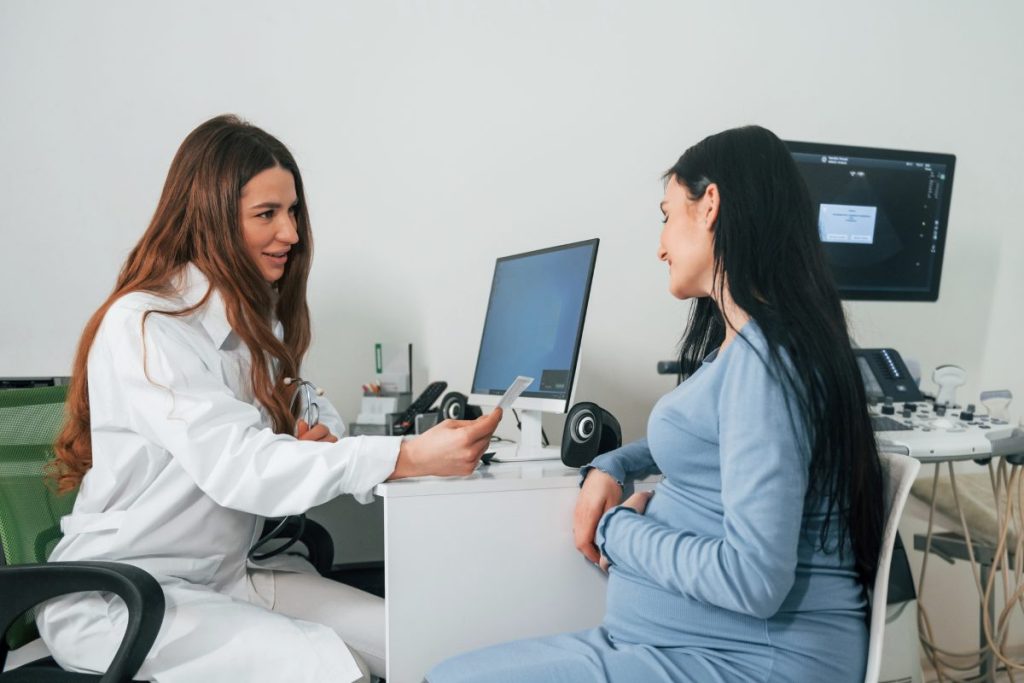 Another consultation. Pregnant woman is in the clinic in cabinet and have health check