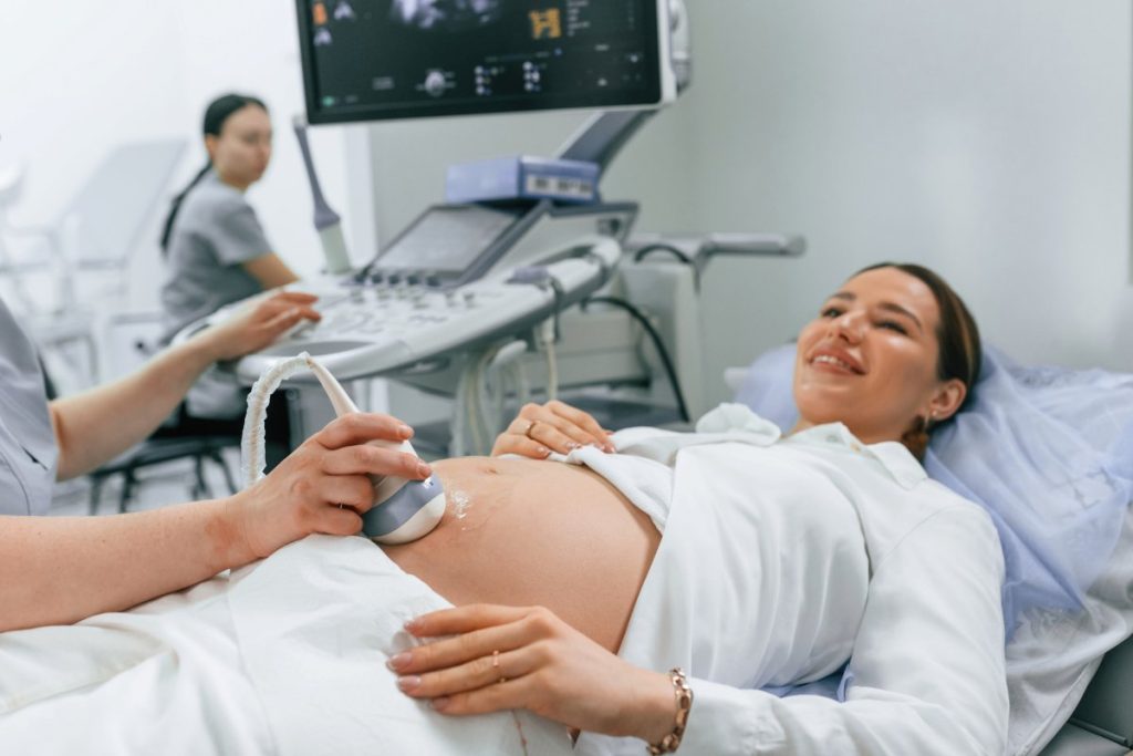 Pregnant woman, is, lying down in the hospital, doctor does ultrasound