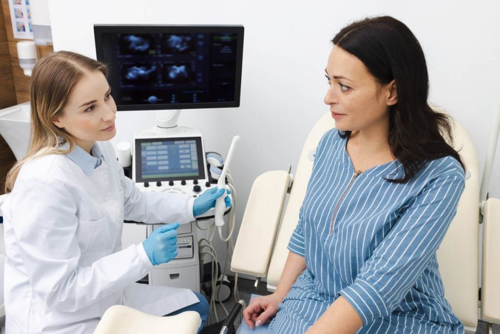 Woman patient during ovarian ultrasound exam in gynecology exam room