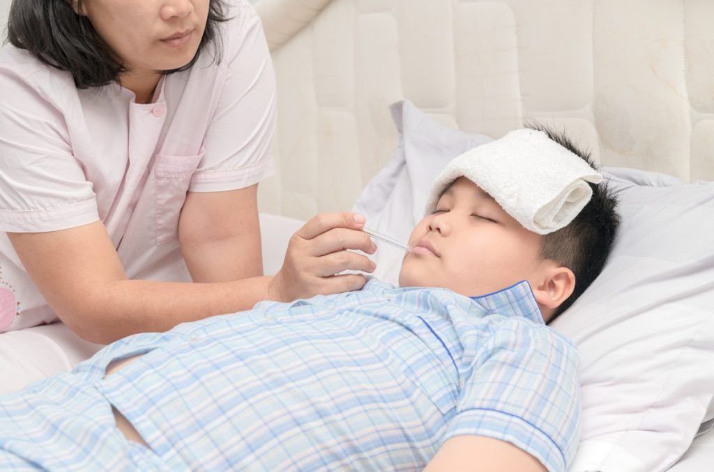Mother checks son's temperature